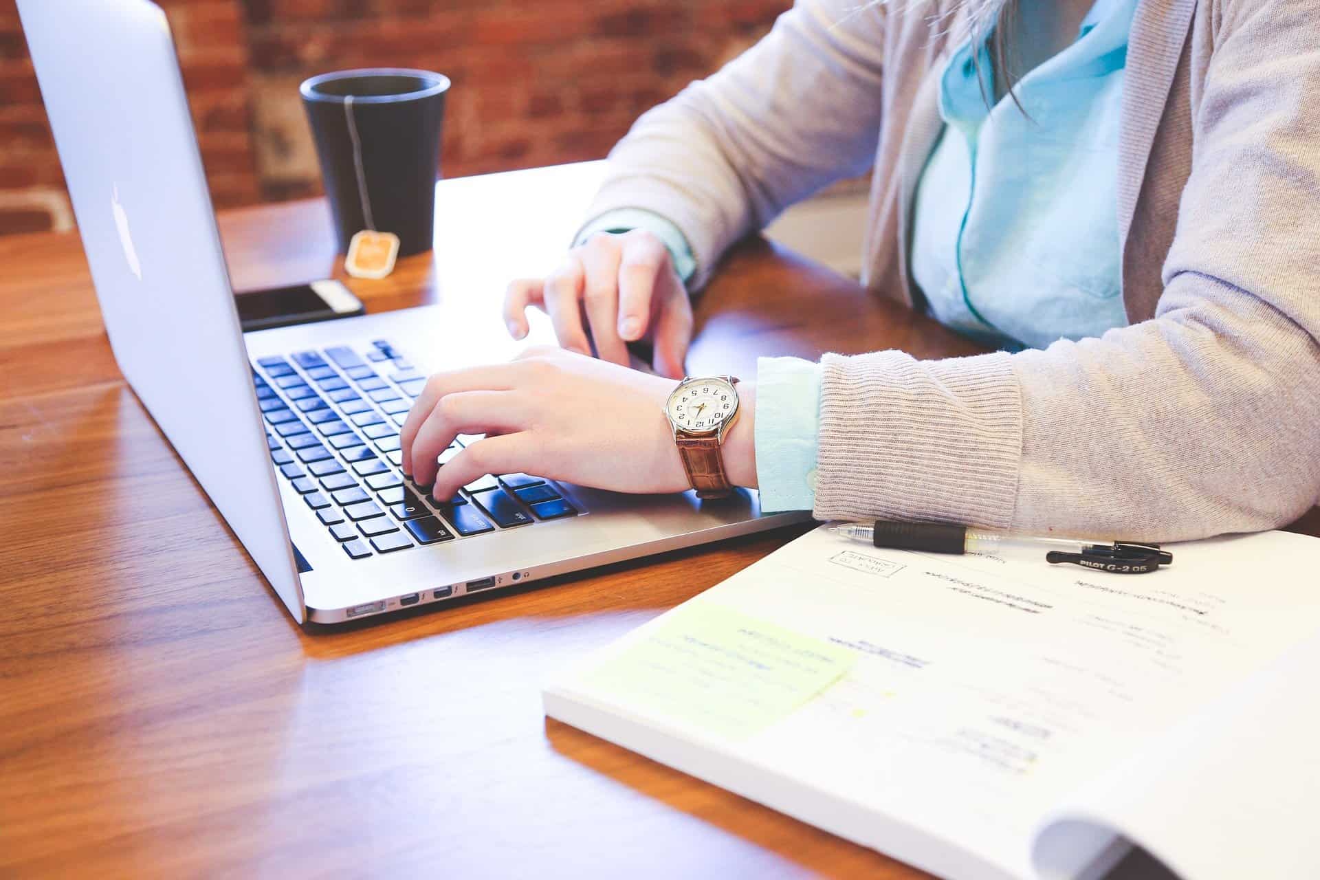 Student typing on a laptop at desk