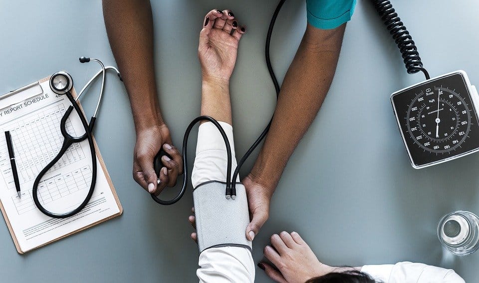 Doctor taking the blood pressure of a patient