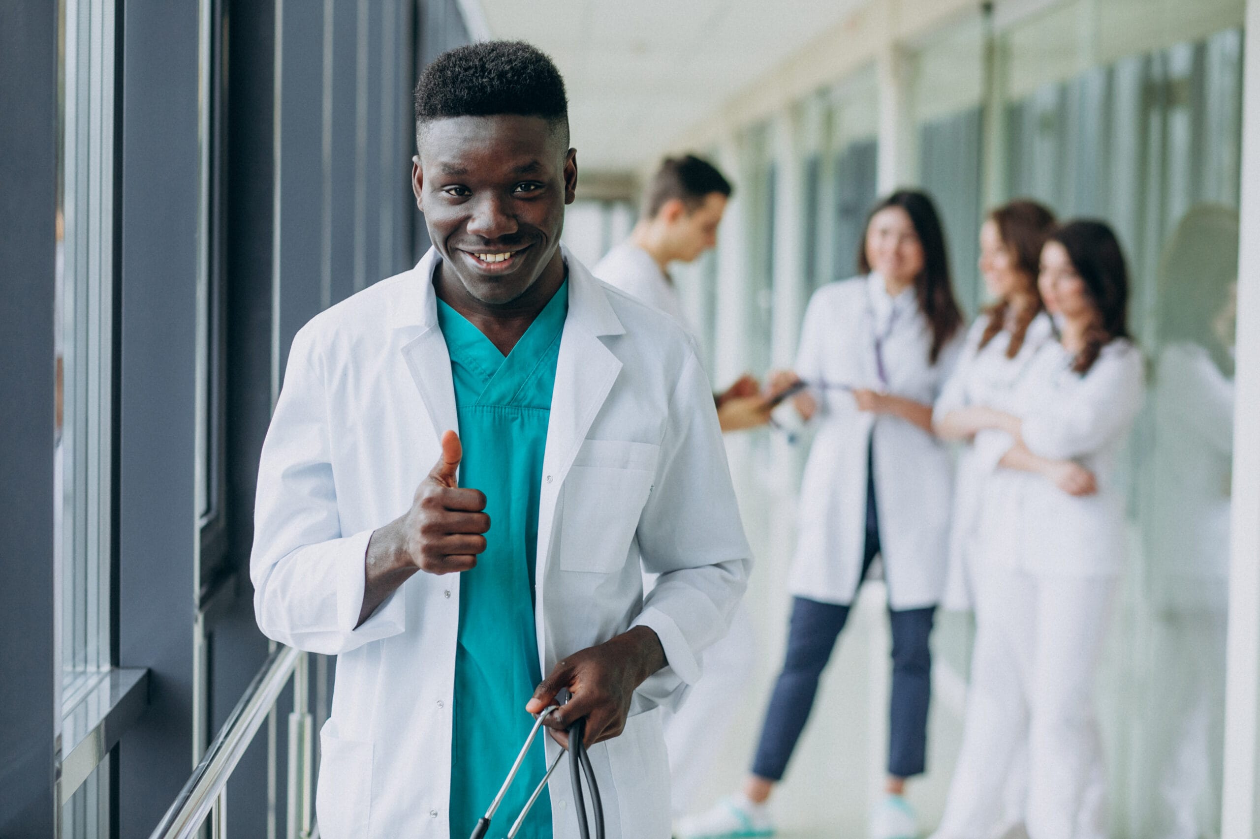 african american doctor man with thumbs up standing corridor hospital scaled