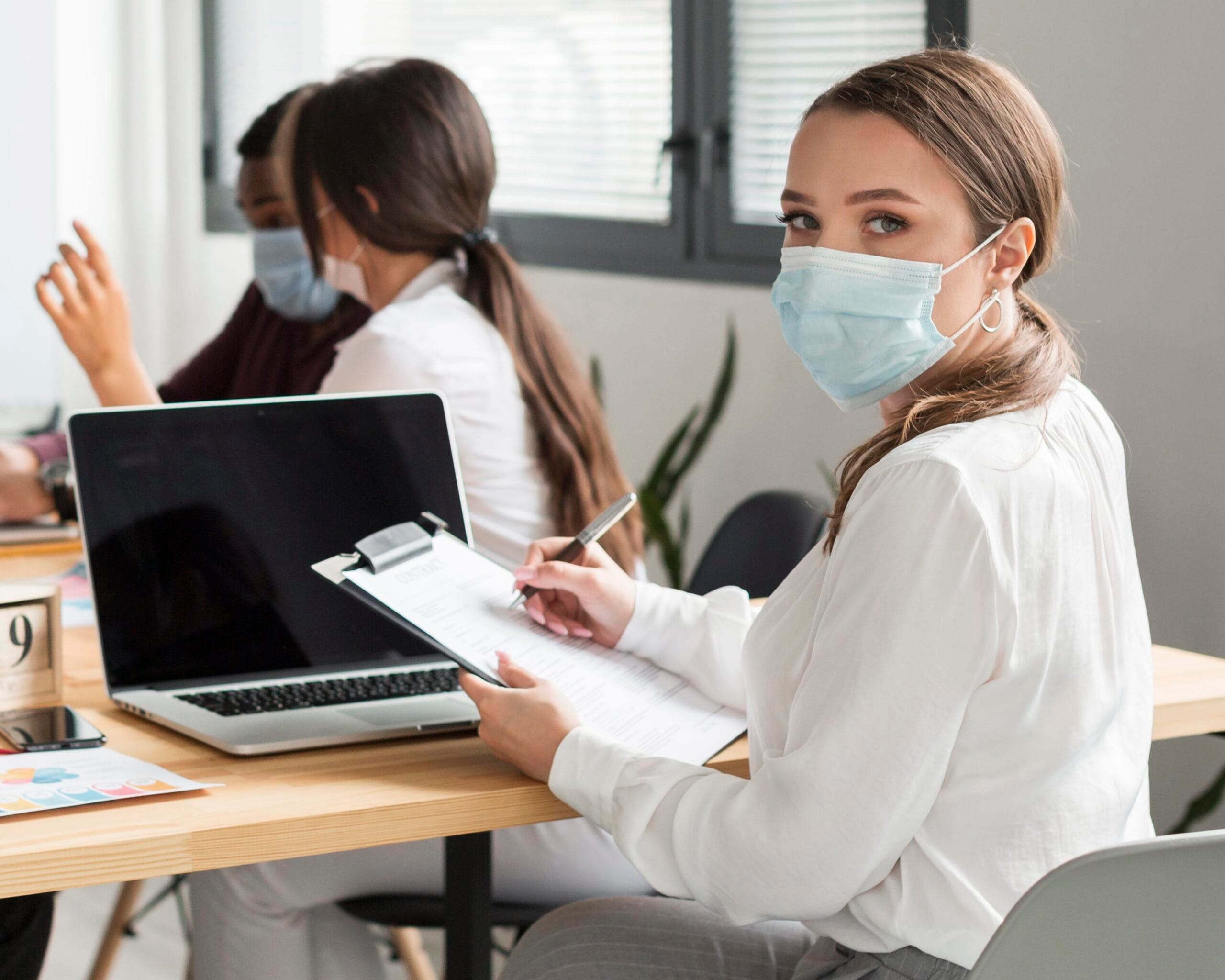 woman working office pandemic with mask scaled