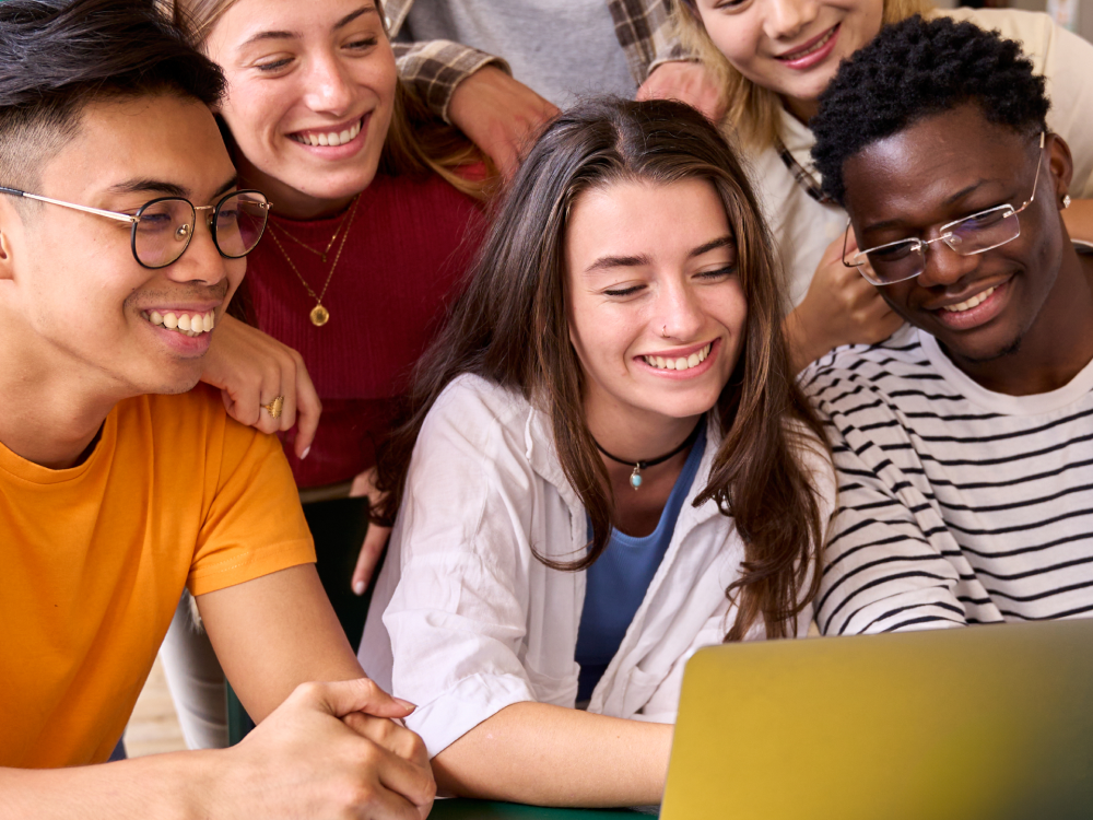 Group of friends enjoying a laptop
